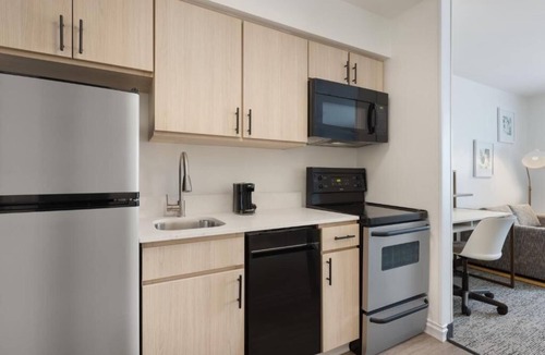 Westshore Hotel | Fully Equipped Kitchen in Modern Suite with Airport Shuttle and Swimming Pool