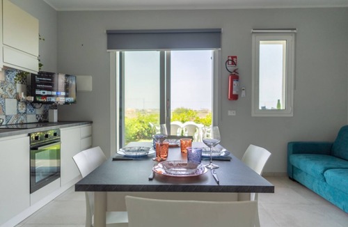 Pachino Apartment | GuestHost - Charming 75 sqm seaview apartment on two levels, for 5 people, located inside the renowned Borgo 84 residence, equipped with swimming pool and cycle path. The property is located just 3 km from the center of Marzamemi, one of the most fascina