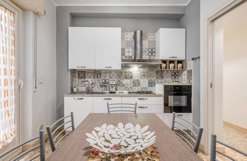 Borgo-Sanzio Apartment | GuestHost - Spacious 100 sqm apartment in Catania, ideal for 8 people, located on the second floor of a building with an elevator (not suitable for disabled individuals). The accommodation features two balconies and is near Villa Bellini, one of the city