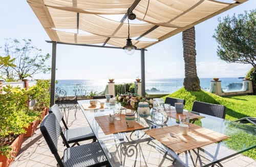 Picanello-Ognina-Barriera-Canalicchio Apartment | GuestHost - This spacious seafront 150 square meters apartment can accommodate up to 6 people. Located on the ground floor, the apartment has a garden overlooking the sea, with a stunning view and private access to the sea on a neighbors shared platform.