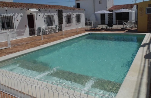 Lora Del Rio House | Holiday Home 'La Fillita' with Shared Pool, Wi-Fi and Air Conditioning