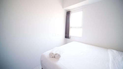 Sidoarjo Apartment | Homey and Comfy 2BR Apartment at Suncity Residence By Travelio