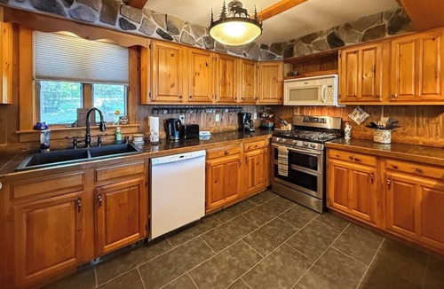 Rome House | Inviting Lakeside Home with direct dock access, patio seating, and gas fireplace