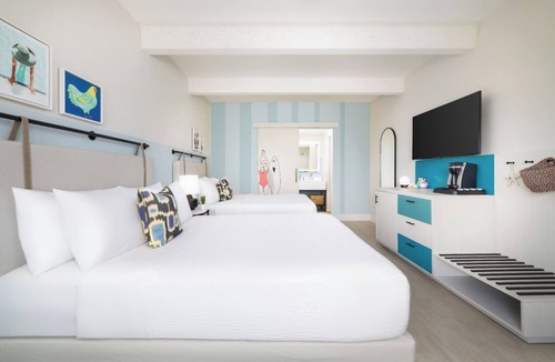 New Town Hotel | Island Charm & Retro Fun | Pools, Comfort Eats, Shuttle & Fire Pits