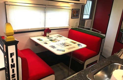 Milton RV Rental | KY Derby-themed glamper nestled in a beautiful treed area of the park. Sleeps 2-3, futon + drop-down table for 2nd bed. Staying here entitles our guests to access all of the park's amenities like the sparkling pool and spa with waterfall and cave gro
