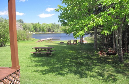 Wetmore Cottage | Lakefront, covered deck, huge backyard with grill, swimming, boat & kayaks!