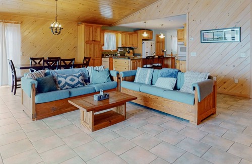 Otis House | Lakefront home with dock, kayak, firepit, screened porch, fireplace, & W/D