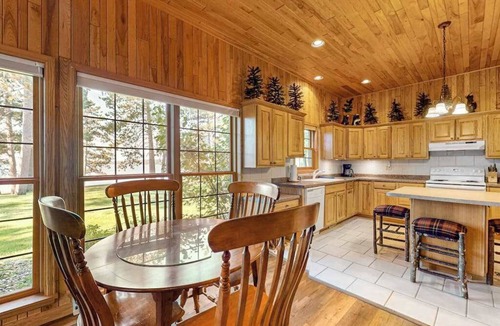 Manitowish Waters Condo | Lakefront resort retreat with screened porch, fireplace, pool, marina, & dining