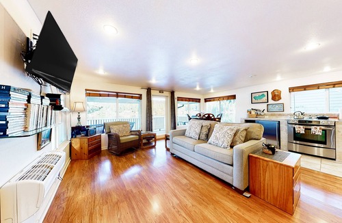 Mason County House | Lakefront studio-like home with beach access, lake views, wood stove, & firepit