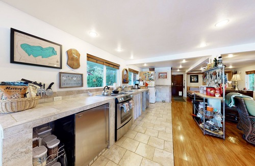 Mason County House | Lakefront studio-like home with beach access, lake views, wood stove, & firepit