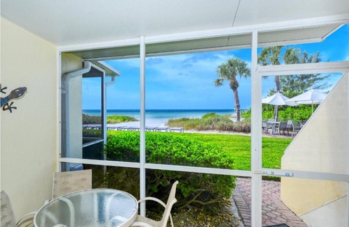 Longboat Key Apartment | LaPlaya 101A Step out to the beach from your screened lanai Light and bright end unit