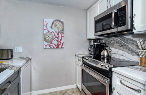 Longboat Key Apartment | LaPlaya 202E-Catch the gentle Gulf breezes on your private balcony beneath the swaying palms.