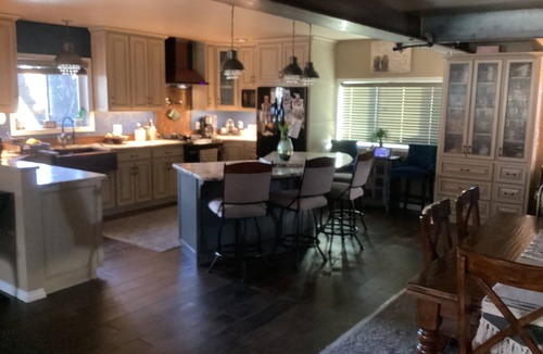 Priest River House | Large patio with patio furniture and an outdoor hot tub.