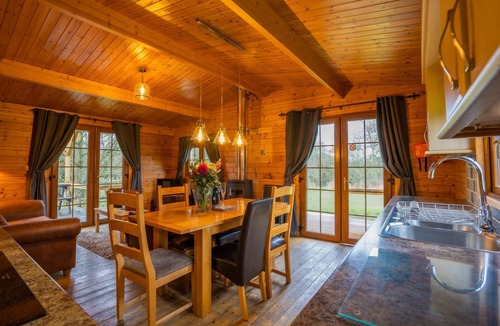 East Huntspill Apartment | Large three bedroom log cabin with private hot tub and decking over looking the beautiful river Brue