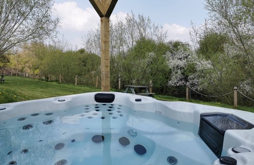 East Huntspill Apartment | Large three bedroom log cabin with private hot tub and decking over looking the beautiful river Brue