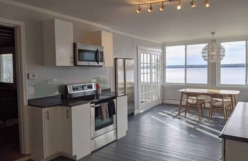 Dedham House | Light-filled lakefront home for up to 15 with private beach and dock near Acadia