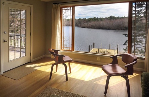 Riverhead House | Light rippling on river, private dock, nature preserve beyond
