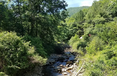 Cattail Creek Cabin | Lightning Bug Lodge at Cattail Creek (treehouse overlooking Cattail Creek in Burnsville NC) between beautiful Asheville and Boone! Perched at nearly 4K elevation...and 10 minutes from historic mountain town of Burnsville. Awesome hiking, gem mining, as...