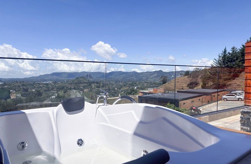 El Penol Apartment | Luxury Stay with Fireplace, Jacuzzi & Overlooking the Rock of El Peñol-Guatape