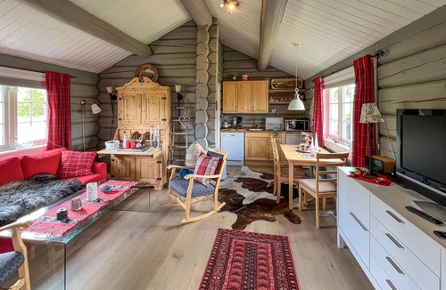Nord-Torpa House | Make yourself comfortable in this open-plan log cabin with a wonderful view of the countryside.