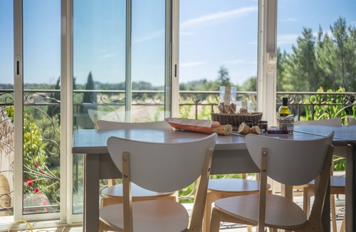 Paradou House | Mas Provençal first floor living room with fireplace and veranda overlooking Alpilles- Vallée des Baux