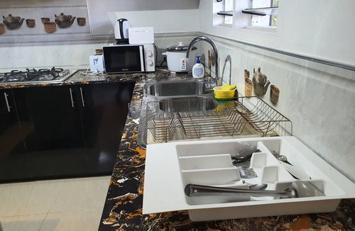 Suva Apartment | Master Bedroom with Shared Kitchen