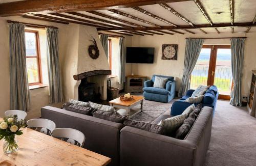 Castle Carrock House | Mill Barn, Castle Carrock, dogs welcome, hot tub with countryside and reservoir views