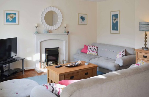 Beadnell Cottage | Modern accommodation with sun room and patio overlooking a small lake.