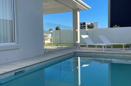 Pelican Waters House | Modern Boho Retreat with Pool, Yard & Beaches Just Minutes Away