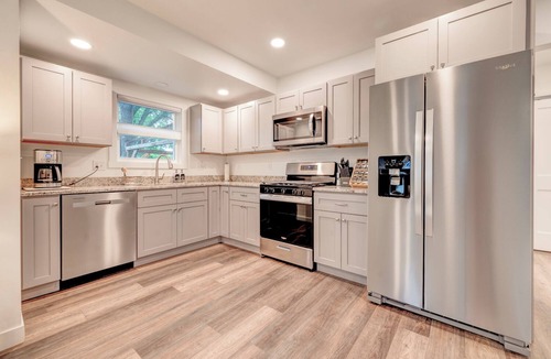 Arnolds Park House | Modern Bungalow Retreat: Walk to Arnolds Park, Relax with Fire Pit & Pergola