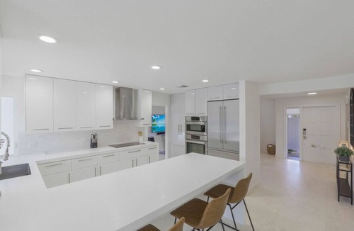 Moorings House | Modern Oasis: Private Beach Access. Minutes from Downtown & Optional Golf Cart