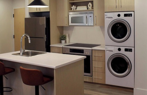 Saint John Apartment | Modern Uptown Gem AC, Gym, & Free Parking Near Saint Joseph’s hospital