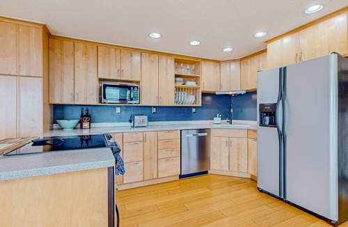 Adelma Beach House | Modern water view retreat with foosball table, expansive deck, and gas fireplace