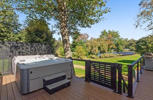 Versailles Villa | Modern Waterfront Retreat with Hot Tub & Pond Views