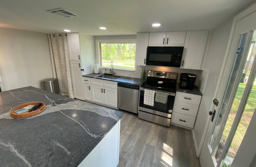 Afton House | Monkey Island Escape sleeps 8, surrounded by nature with views of Grand Lake.