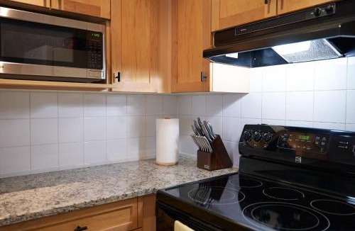 Canmore Apartment | Mtn View Escape with King Size Bed with Outdoor Pool - Banff Pass Included!