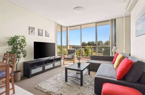 Sydney Olympic Park Apartment | Ocean Oasis: Pool, Man-Made Beach, Ultimate Escape