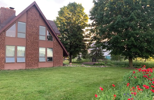 Oneida House | Our Thunder Moon Farm Stay- sleeps 7, framed by wildflowers. 4 miles to GB.