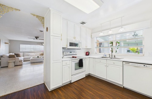 Surfside Estates House | Pet-friendly 3BR beachside home with fenced yard, hot tub, Green Egg grill, and beach gear! Walk to the ocean and relax in your private coastal backyard oasis.