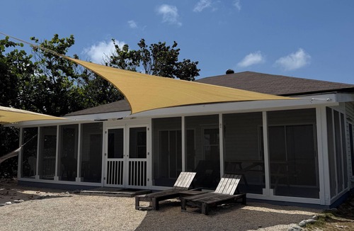 West End House | Private 2-b beachfront cottage w/hammocks, screened-in veranda, sunsets & more!
