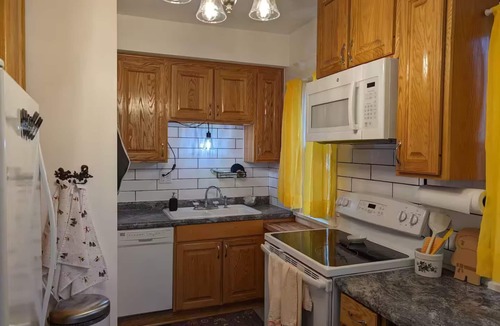 Merriam Park Apartment | Quiet Balcony midst lilac trees awaits! Sleeps 4, dog and child friendly!