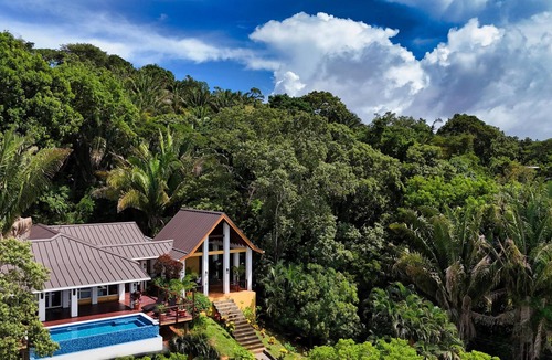 Gibson Bight House | Relax at this hillside retreat that overlooks the lush forest and the Caribbean.