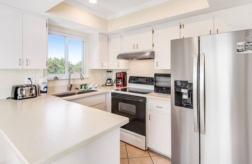 Holmes Beach House | Remodeled duplex with heated private pool - close to beach, dogs welcome