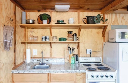 Lakeside Cabin | Remote 1 BR Lakefront Cabin. Features a King loft bed with lake views, private dock, and provided paddleboards/kayaks. Perfect for fishing, stargazing, and quiet nature escapes.