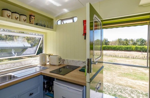 Birdham House | Restored Showman's Carriage with King Bed