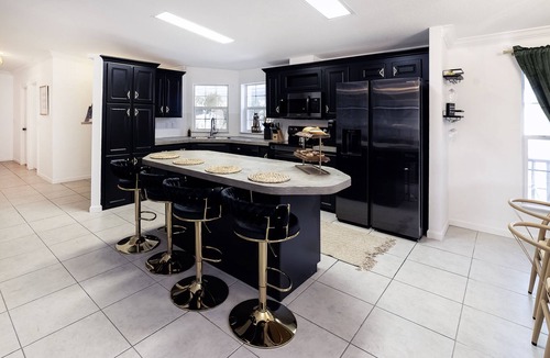 Weeki Wachee Gardens House | River home with huge arcade, hot tub, kayaks, mini golf course, 80in TV