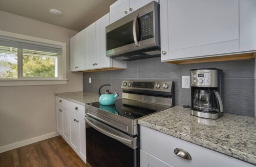 Brookings Cottage | Riverfront Cottage with Hot Tub 1/4 mi from Beach