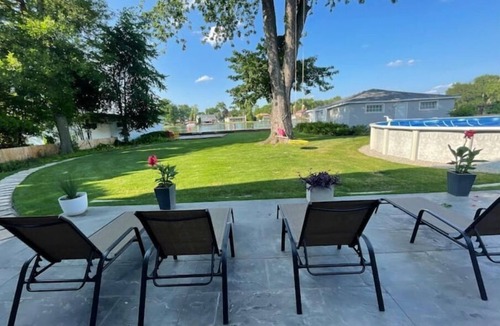 Menasha House | Riverfront Oasis - Hot tub- Seasonal heated pool