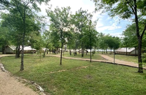 Bastrop RV Rental | Romantic Lakefront Safari Tent with Fire Pit and Peaceful Views near Bastrop, Texas