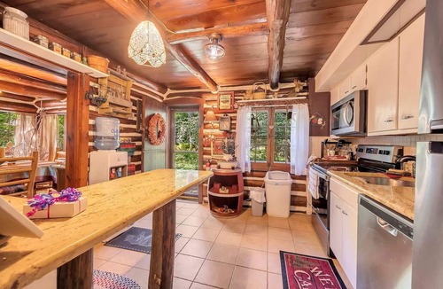 East Stroudsburg Cabin | Rustic Rest Log Cabin, with hot tub and stream, near Poconos attractions.